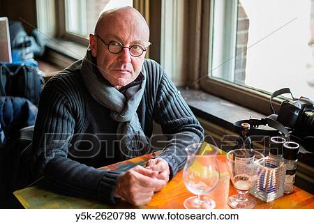 Rotterdam, Netherlands. Balding, middle aged man finishing his two glases of special beer. View Large Photo Image Stock Photo - Rotterdam, Netherlands. Balding, middle aged man finishing his two glases of special beer.. Fotosearch