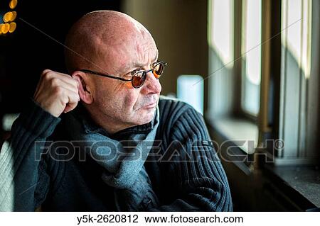 Rotterdam, Netherlands. Middle aged balding man overlooking the river from his restaurant lunch table, while dealing with a depression. View Large Photo Image Stock Image - Rotterdam, Netherlands. Middle aged balding man overlooking the river from his restaurant lunch table, while dealing with a depression.. Fotosearch