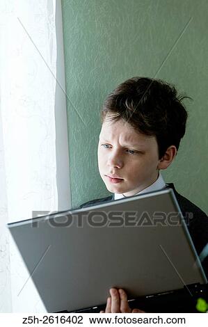 Russia. Belgorod region. Village Solomino. The boy twelve years preparing for school. View Large Photo Image Stock Image - Russia. Belgorod region. Village Solomino. The boy twelve years preparing for school.. Fotosearch