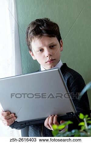 Stock Image - Russia. Belgorod region. Village Solomino. The boy twelve years preparing for school.. Fotosearch