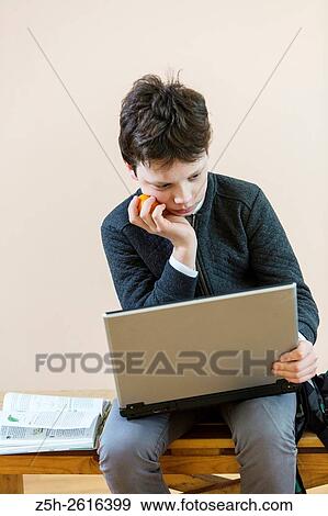 Stock Photo - Russia. Belgorod region. Village Solomino. The boy twelve years preparing for school.. Fotosearch