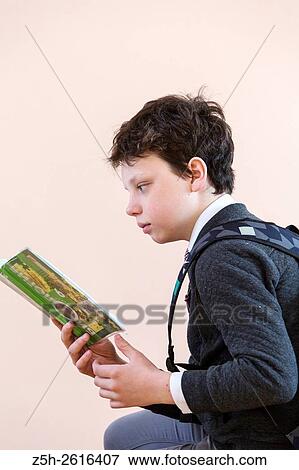 Stock Photo - Russia. Belgorod region. Village Solomino. The boy twelve years preparing for school.. Fotosearch