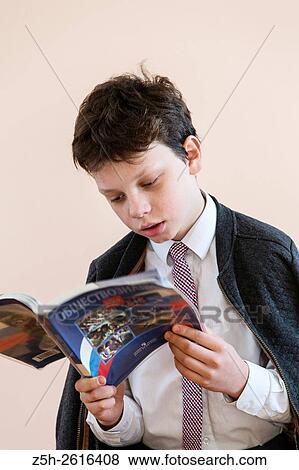 Stock Photo - Russia. Belgorod region. Village Solomino. The boy twelve years preparing for school.. Fotosearch