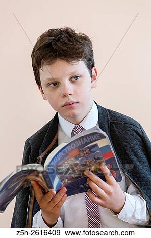 Stock Photo - Russia. Belgorod region. Village Solomino. The boy twelve years preparing for school.. Fotosearch