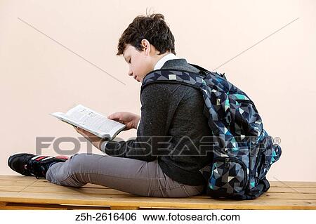 Stock Photograph - Russia. Belgorod region. Village Solomino. The boy twelve years preparing for school.. Fotosearch