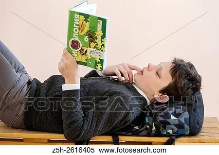 Stock Photography - Russia. Belgorod region. Village Solomino. The boy twelve years preparing for school.. Fotosearch