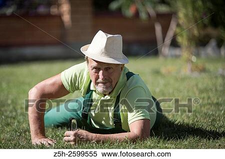 Stock Photography - Russian Federation. Belgorod region. The village Solomino. The man in the autumn garden.. Fotosearch