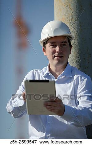 Russian Federation. Belgorod. Young engineer on a construction site. View Large Photo Image Stock Photo - Russian Federation. Belgorod. Young engineer on a construction site.. Fotosearch