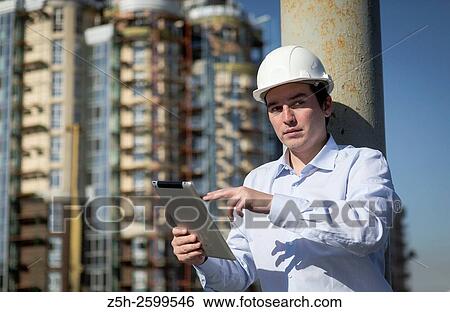 Russian Federation. Belgorod. Young engineer on a construction site. View Large Photo Image Stock Photograph - Russian Federation. Belgorod. Young engineer on a construction site.. Fotosearch
