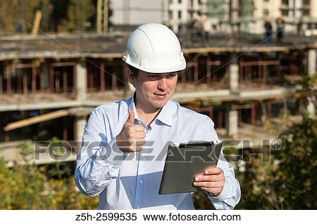Russian Federation. Belgorod. Young engineer on a construction site. View Large Photo Image Stock Photography - Russian Federation. Belgorod. Young engineer on a construction site.. Fotosearch
