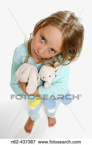 Sad little girl with pigtails top view, tightens the puppet's arms View Large Photo Image Stock Photo - Sad little girl with pigtails top view, tightens the puppet's arms. Fotosearch