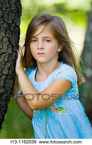 Sad young girl 6 years next to a tree View Large Photo Image Stock Photo - Sad young girl 6 years next to a tree. Fotosearch