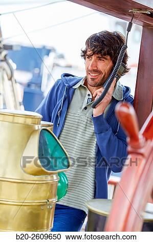Stock Image - Sailor at the helm of a sailboat, galleon. Basque Country. Spain. Fotosearch