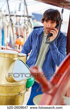 Stock Photo - Sailor at the helm of a sailboat, galleon. Basque Country. Spain. Fotosearch