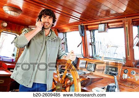 Stock Photography - Sailor at the helm of a sailboat, galleon. Basque Country. Spain. Fotosearch