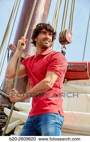 Stock Image - Sailor. Ropes sail of a sailboat, galleon. Basque Country. Spain. Fotosearch
