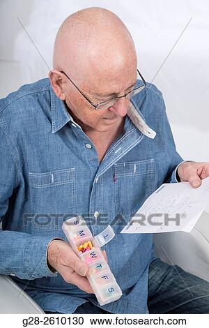 Senior man holding a prescription and a weekly pill organiser View Large Photo Image Stock Image - Senior man holding a prescription and a weekly pill organiser. Fotosearch