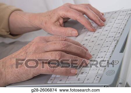 Senior Woman? s hands typing on a white computer keyboard View Large Photo Image Picture - Senior Woman? s hands typing on a white computer keyboard. Fotosearch