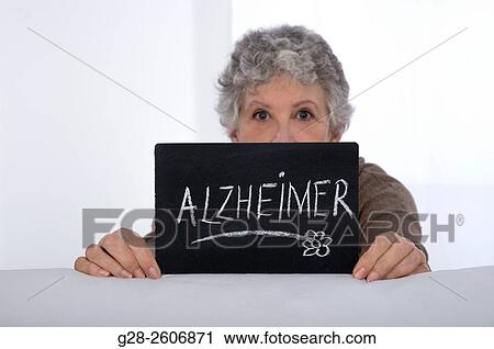 Senior Woman with grey hair holding a black slate with Alzheimer written on it View Large Photo Image Stock Image - Senior Woman with grey hair holding a black slate with Alzheimer written on it. Fotosearch