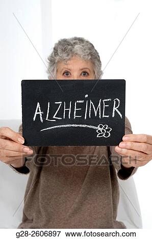 Senior Woman with grey hair holding a black slate with Alzheimer written on it View Large Photo Image Stock Photo - Senior Woman with grey hair holding a black slate with Alzheimer written on it. Fotosearch