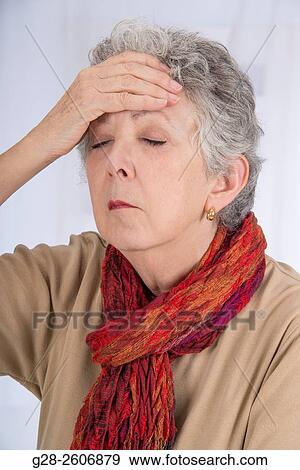 Senior woman with grey hair, holding her forehead with one hand to relieve tiredness, sinusitis and headache, eyes closed View Large Photo Image Stock Photo - Senior woman with grey hair, holding her forehead with one hand to relieve tiredness, sinusitis and headache, eyes closed. Fotosearch