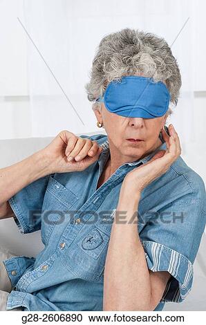Senior woman with grey hair, with a blue mask upon her eyes, taking a nap View Large Photo Image Stock Image - Senior woman with grey hair, with a blue mask upon her eyes, taking a nap. Fotosearch