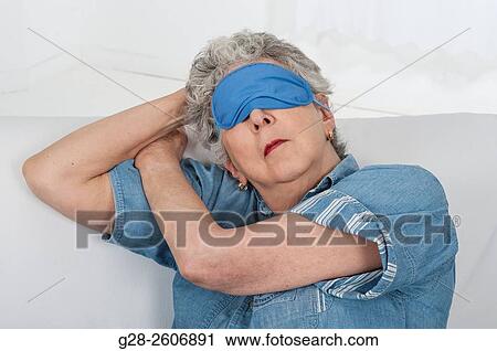 Senior woman with grey hair, with a blue mask upon her eyes, taking a nap View Large Photo Image Stock Image - Senior woman with grey hair, with a blue mask upon her eyes, taking a nap. Fotosearch