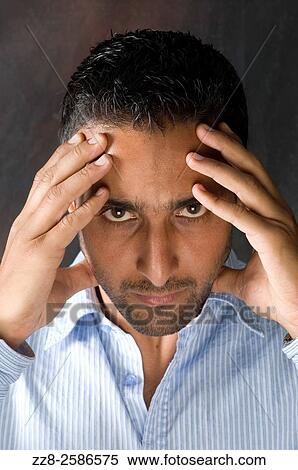 Serious man head in hands staring at camera. View Large Photo Image Stock Photography - Serious man head in hands staring at camera.. Fotosearch