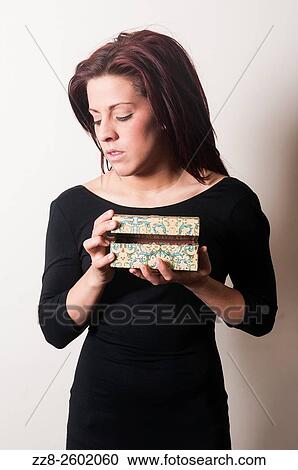 Serious young woman holding a vintage jewelry box. View Large Photo Image Stock Image - Serious young woman holding a vintage jewelry box.. Fotosearch