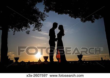 Stock Photo - Silhouette couple at sunset.. Fotosearch