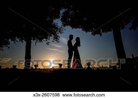 Silhouette couple at sunset. View Large Photo Image Stock Photo - Silhouette couple at sunset.. Fotosearch