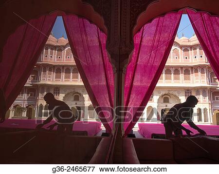 Stock Photo - Silhouette of men working in front of Hawa Mahal, Jaipur, Rajasthan, India. Fotosearch