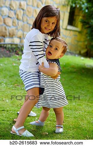 Sisters playing in the park. Girls. Getaria. Gipuzkoa. Basque Country. Spain View Large Photo Image Stock Image - Sisters playing in the park. Girls. Getaria. Gipuzkoa. Basque Country. Spain. Fotosearch