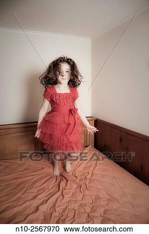 Six year old girl on her bed. View Large Photo Image Stock Image - Six year old girl on her bed.. Fotosearch