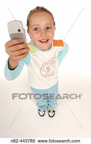 Smiling little girl top view take a photo with her cell phone raising her arm View Large Photo Image Stock Photography - Smiling little girl top view take a photo with her cell phone raising her arm. Fotosearch