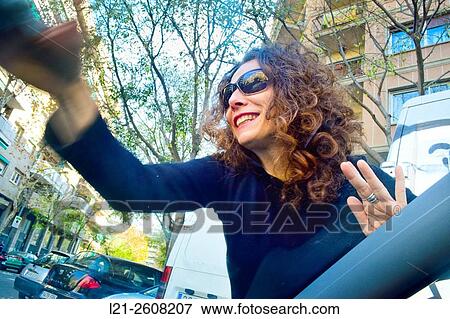 Smiling woman with dark glasses on cleaning her car in a street. View Large Photo Image Stock Photo - Smiling woman with dark glasses on cleaning her car in a street.. Fotosearch