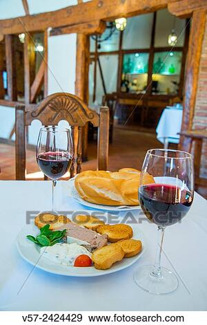 Stock Photo - Spanish appetizer: two glasses of red wine and tapa of pate and sliced bread in a typical restaurant. Navalcarnero, Madrid province, Spain.. Fotosearch
