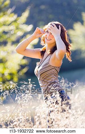 Spontaneous teen girl in high-grass View Large Photo Image Stock Image - Spontaneous teen girl in high-grass. Fotosearch