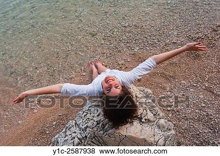 Stock Photo - Spreading arms above water and happy. Fotosearch