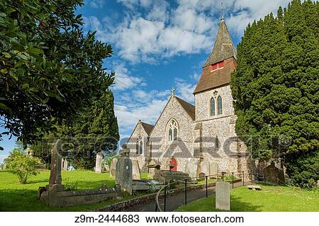 Stock Image - St Cosmas and St Damian church in the village of Keymer, West Sussex, England. South Downs National Park.. Fotosearch