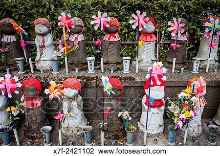 Stock Image - Statues of Jizo dedicated to dead unborn children, in Zojoji temple, Tokyo, Japan.. Fotosearch