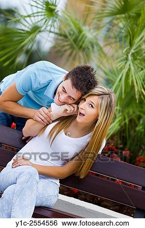 Stock Photograph - Stock Photo - Teen couple girl and boy both listen to cellphone talk. Fotosearch