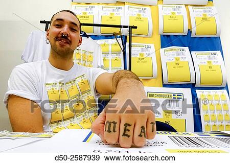 Stock Photo - STOCKHOLM SWEDEN Art student at Konstfack selling posters and T-shirts with meat labels.. Fotosearch