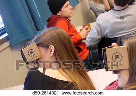 STOCKHOLM, SWEDEN Class 8A at the Blommenbergsskolan school in Grndal gets a hands on demonstration of Google Glasses, a 3 D Virtual Reality (VR) headset made of cardboard and 3D glasses to view special photos on a mobile phone. The cardboard box is slott View Large Photo Image Stock Image - STOCKHOLM, SWEDEN Class 8A at the Blommenbergsskolan school in Grndal gets a hands on demonstration of Google Glasses, a 3 D Virtual Reality (VR) headset made of cardboard and 3D glasses to view special photos on a mobile phone. The cardboard box is slott. Fotosearch