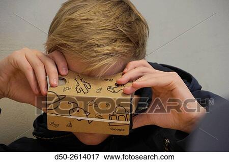 STOCKHOLM, SWEDEN Class 8A at the Blommenbergsskolan school in Grndal gets a hands on demonstration of Google Glasses, a 3 D Virtual Reality (VR) headset made of cardboard and 3D glasses to view special photos on a mobile phone. The cardboard box is slott View Large Photo Image Stock Photo - STOCKHOLM, SWEDEN Class 8A at the Blommenbergsskolan school in Grndal gets a hands on demonstration of Google Glasses, a 3 D Virtual Reality (VR) headset made of cardboard and 3D glasses to view special photos on a mobile phone. The cardboard box is slott. Fotosearch