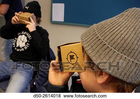 STOCKHOLM, SWEDEN Class 8A at the Blommenbergsskolan school in Grndal gets a hands on demonstration of Google Glasses, a 3 D Virtual Reality (VR) headset made of cardboard and 3D glasses to view special photos on a mobile phone. The cardboard box is slott View Large Photo Image Stock Photo - STOCKHOLM, SWEDEN Class 8A at the Blommenbergsskolan school in Grndal gets a hands on demonstration of Google Glasses, a 3 D Virtual Reality (VR) headset made of cardboard and 3D glasses to view special photos on a mobile phone. The cardboard box is slott. Fotosearch