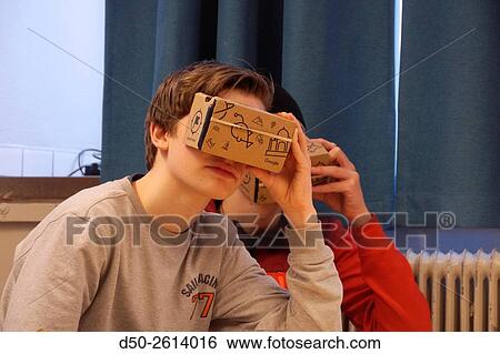 STOCKHOLM, SWEDEN Class 8A at the Blommenbergsskolan school in Grndal gets a hands on demonstration of Google Glasses, a 3 D Virtual Reality (VR) headset made of cardboard and 3D glasses to view special photos on a mobile phone. The cardboard box is slott View Large Photo Image Stock Photograph - STOCKHOLM, SWEDEN Class 8A at the Blommenbergsskolan school in Grndal gets a hands on demonstration of Google Glasses, a 3 D Virtual Reality (VR) headset made of cardboard and 3D glasses to view special photos on a mobile phone. The cardboard box is slott. Fotosearch