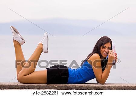 Stock Image - Student girl with homework in hands. Fotosearch