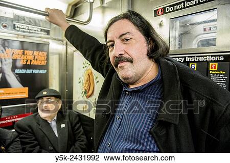 Subway, New York, Manhattan. Caucasian man wearing a mustage and his retired father, commuting by subway through Manhattan. View Large Photo Image Stock Image - Subway, New York, Manhattan. Caucasian man wearing a mustage and his retired father, commuting by subway through Manhattan.. Fotosearch