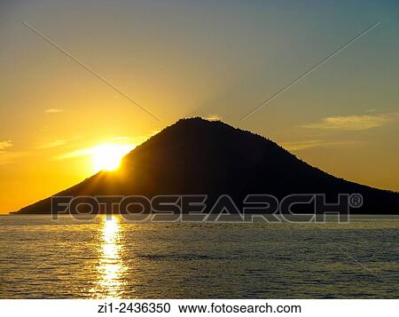 Stock Image - Sunset and volcano Manado Tua at Manado, Sulawesi, Indonesia. Fotosearch